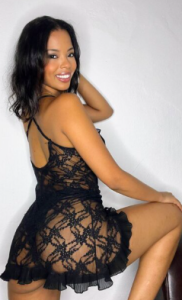 Verified Hawassa escort on tour wearing a black lace outfit highlighting a curvy figure.